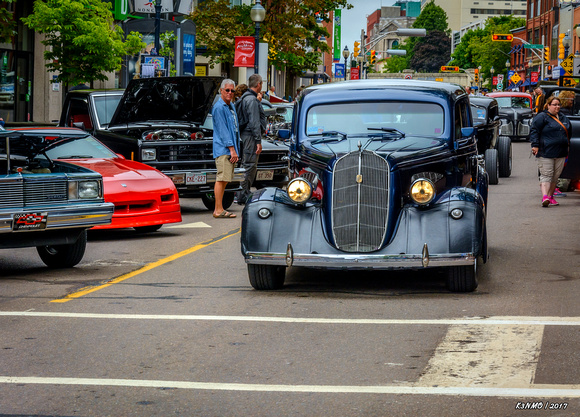 1936 Nash sedan entering downtown