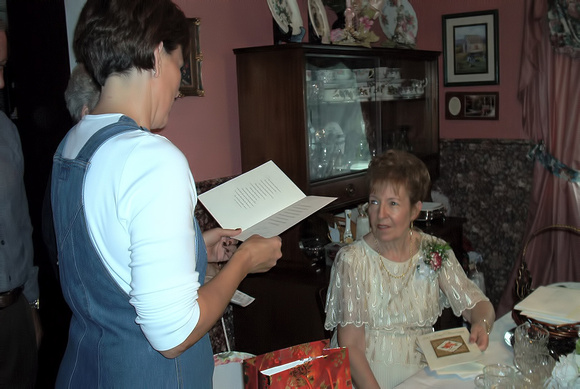 Cousin Mary-Anne reading to Mom during her 50th Anniversary....